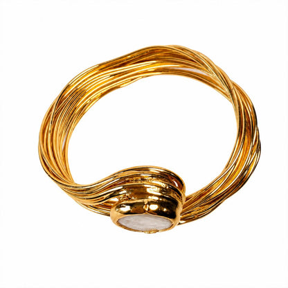 A gold-plated twisted wire cuff bracelet with a polished oval white stone centerpiece, shown on a solid white background.