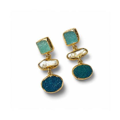 A pair of gold drop earrings featuring textured green and deep blue stones, a white pearl accent, and a square green stone at the top, shown on a white background.