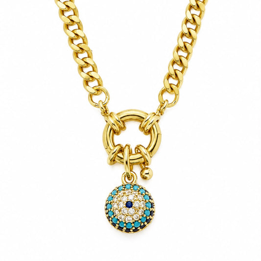 A gold-toned chunky chain necklace with a ring clasp and a dangling evil eye charm. The charm features a gold border, turquoise blue stones, and a central dark blue stone surrounded by small clear stones, set against a plain white background.